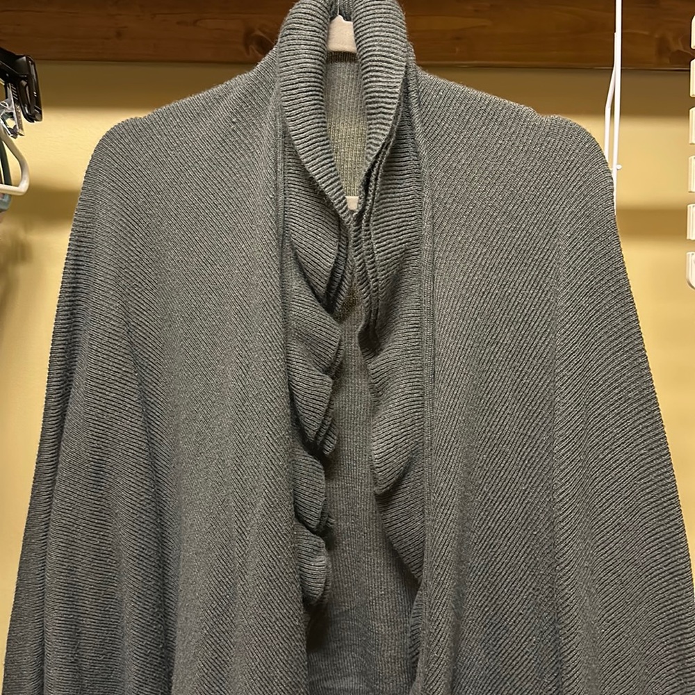 Dark gray shawl with ruffle collar.